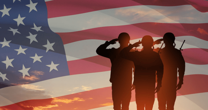 Veterans saluting American flag